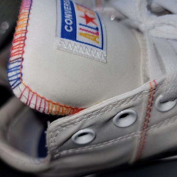 white converse with rainbow stitching